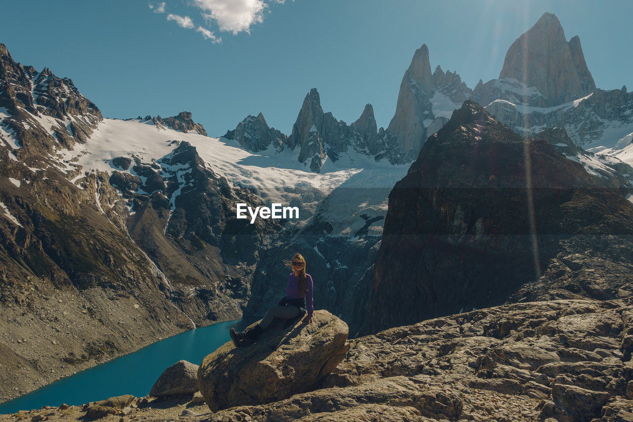 rear view of man sitting on mountain