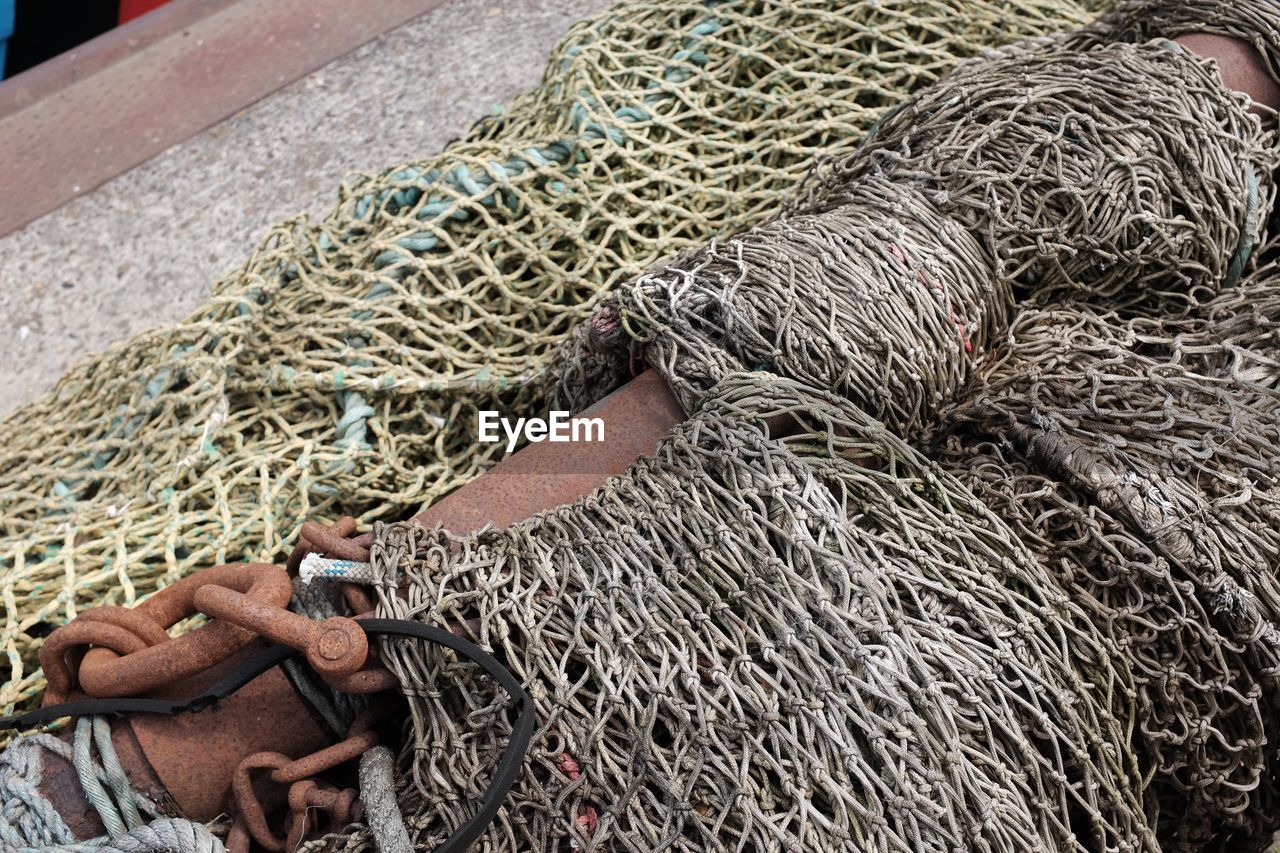 High angle view of fishing nets and buoys on pier