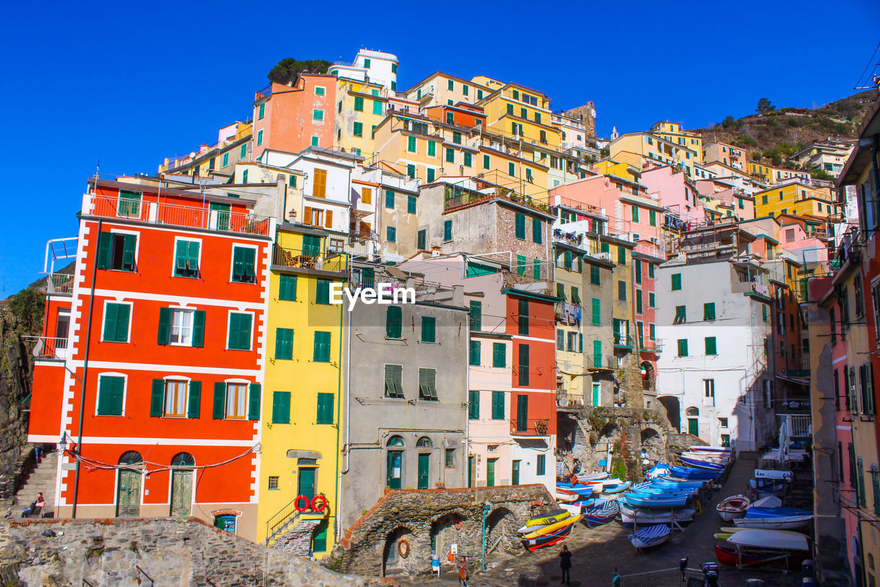 Multi colored buildings in city against clear sky