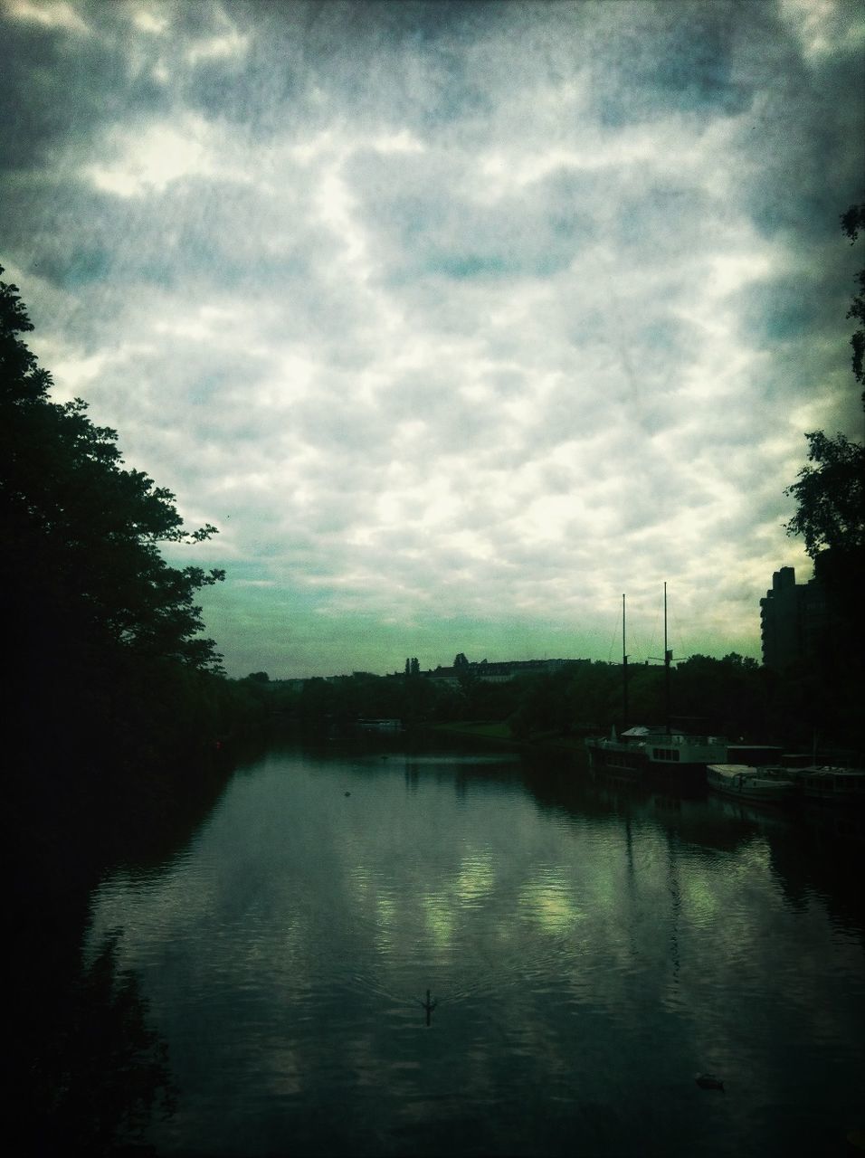 SCENIC VIEW OF LAKE AGAINST CLOUDY SKY