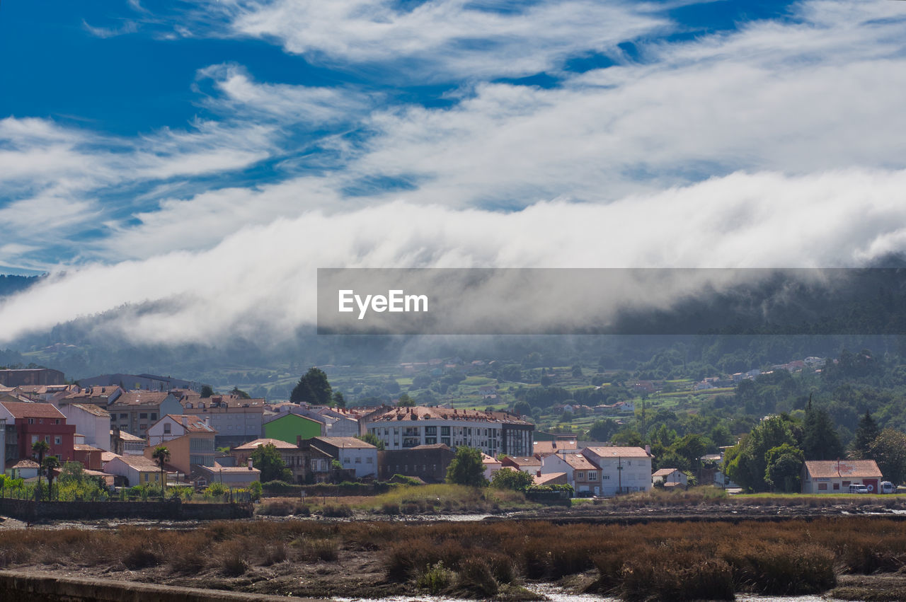 A sea of white clouds going down the mountains to the village of noia in galicia