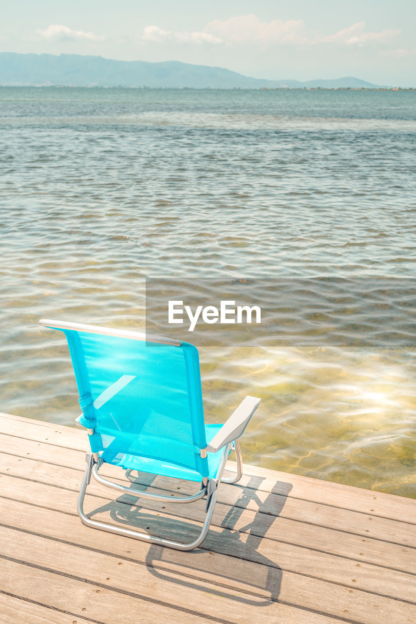 BLUE CHAIR IN SWIMMING POOL
