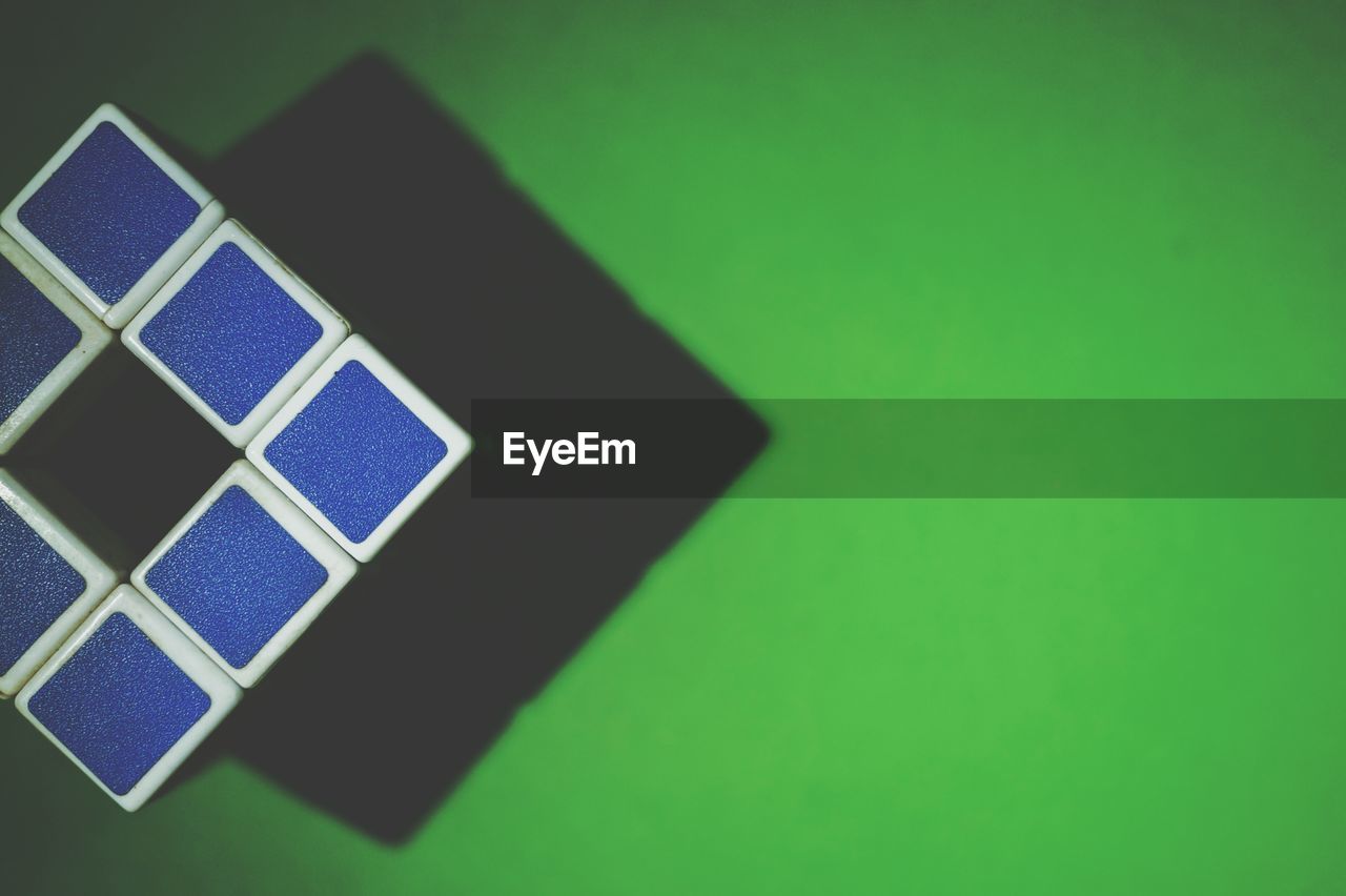 Plastic cube on green surface