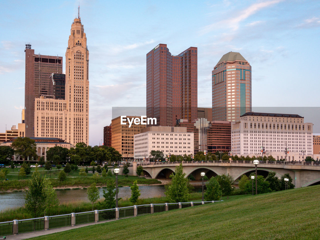 Buildings in city against cloudy sky