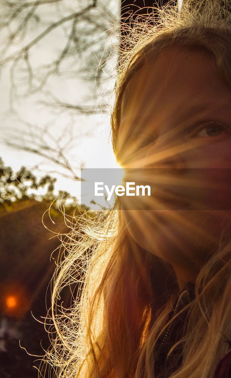 Close-up portrait of girl with sunbeam