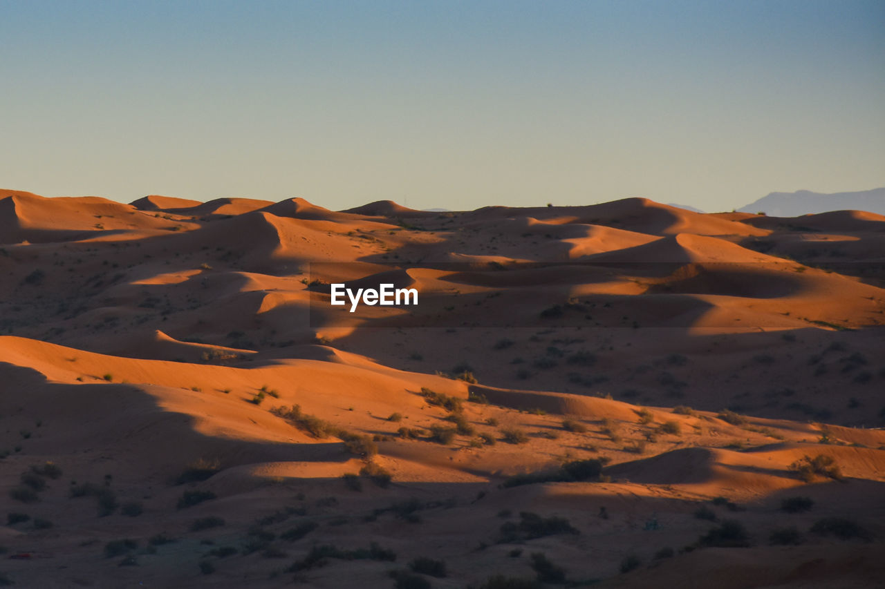 Scenic view of desert against clear sky