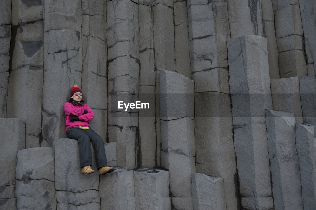 Woman sitting rock formation