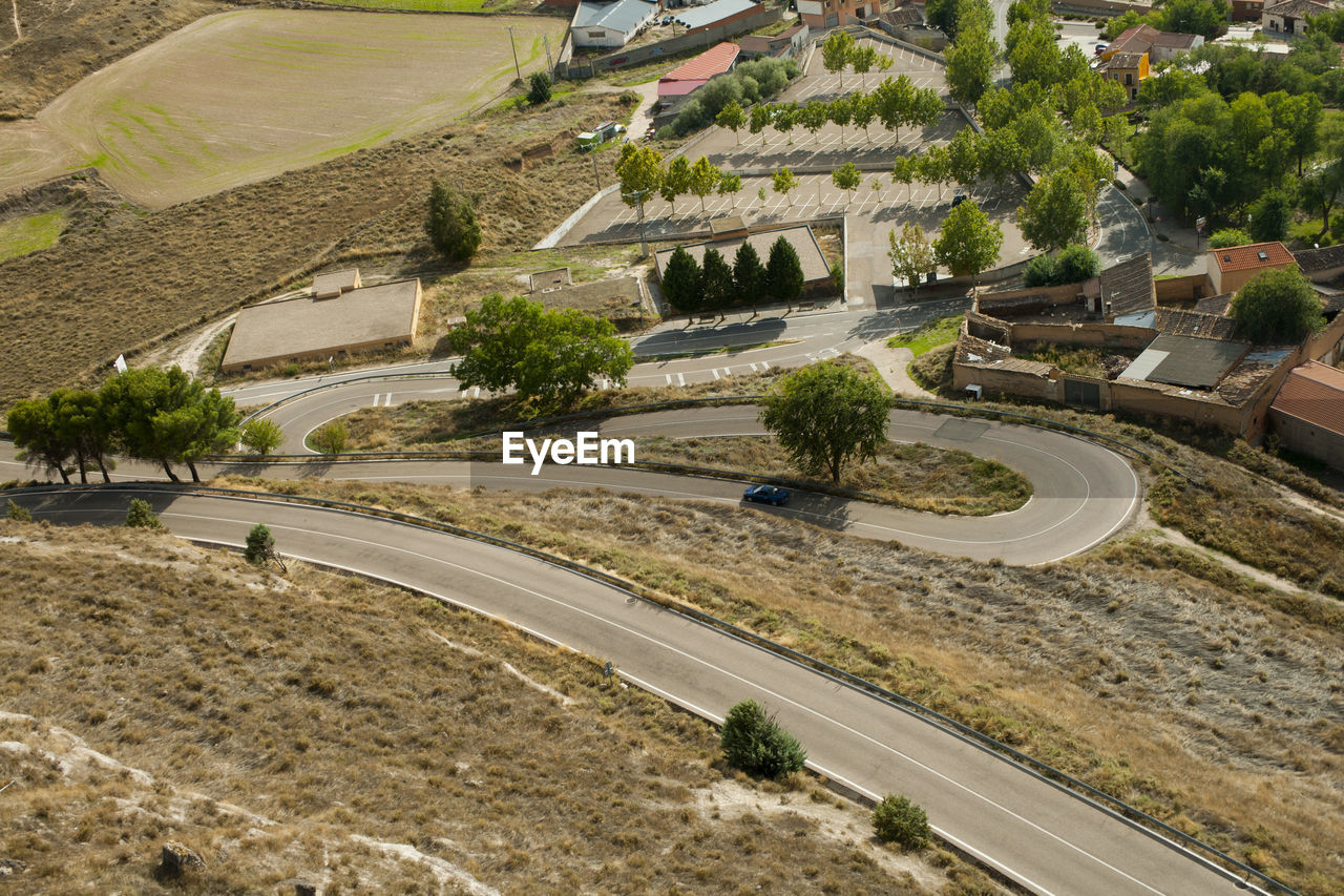 HIGH ANGLE VIEW OF STREET AMIDST BUILDINGS