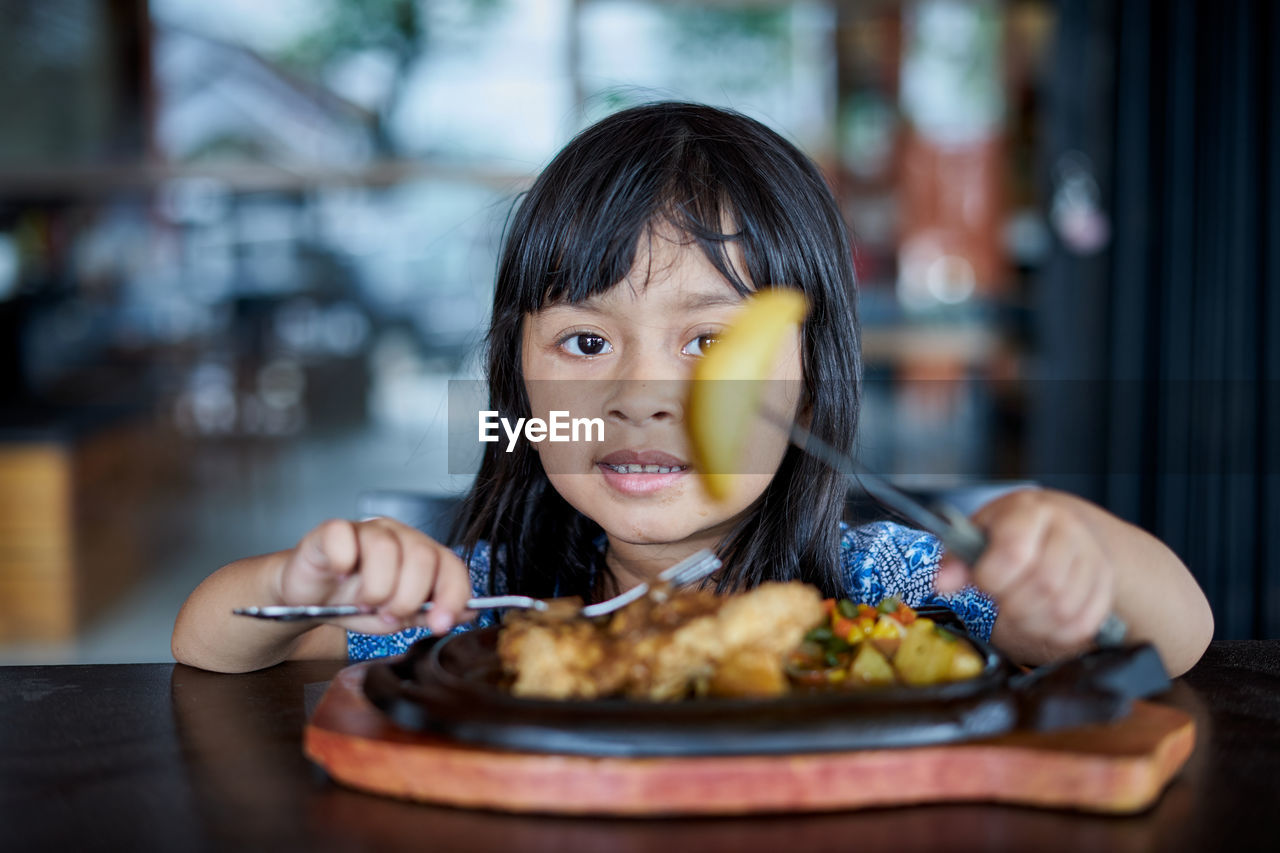 Portrait of girl eating food