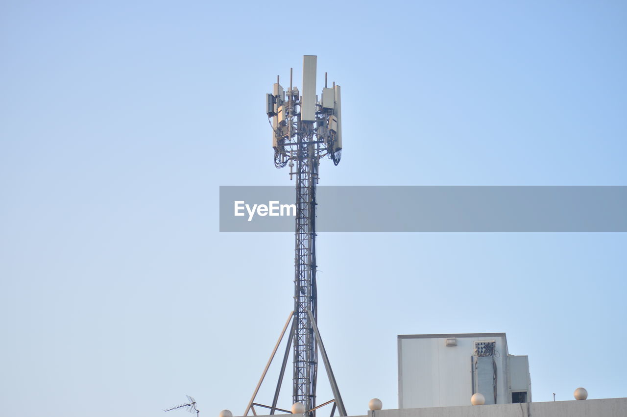 sky, architecture, clear sky, built structure, copy space, blue, technology, no people, tower, nature, day, sunny, mast, metal, outdoors, low angle view, communications tower, industry, construction equipment, antenna, communication