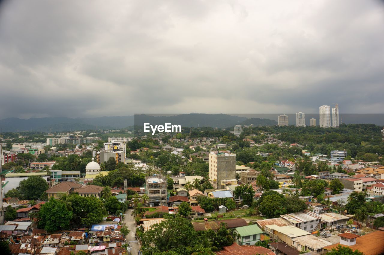 HIGH ANGLE VIEW OF BUILDINGS AGAINST SKY