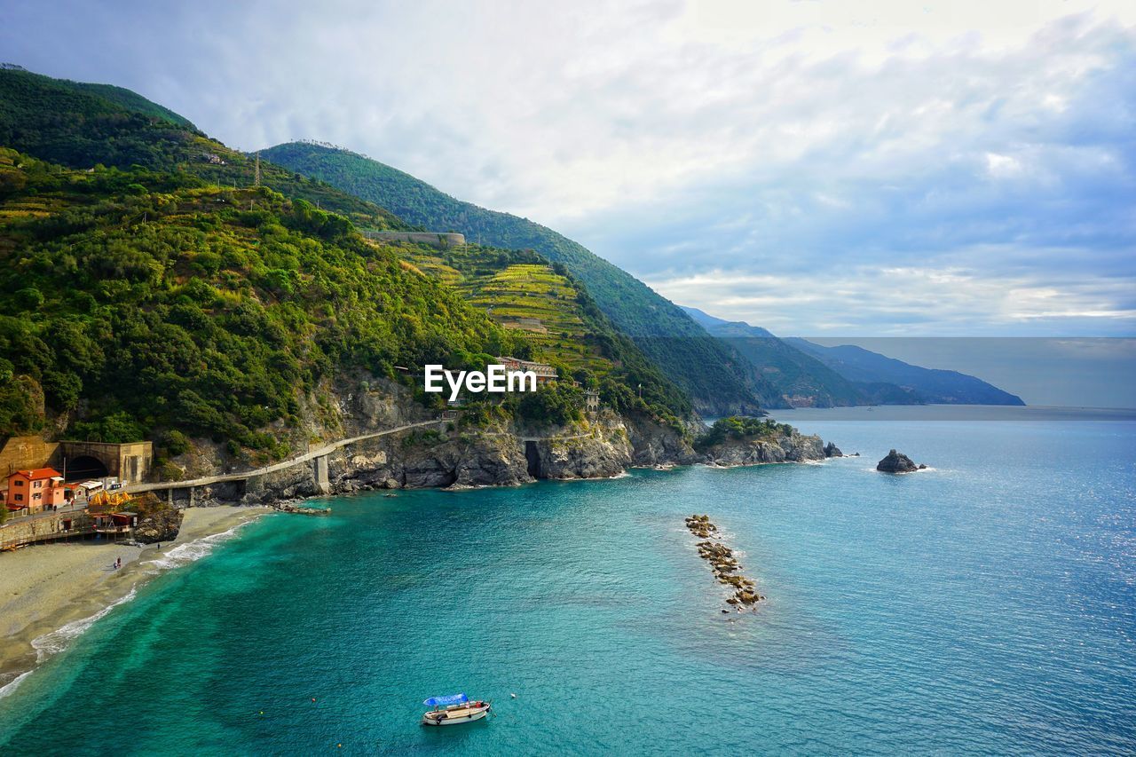 Scenic view of sea and mountains against sky