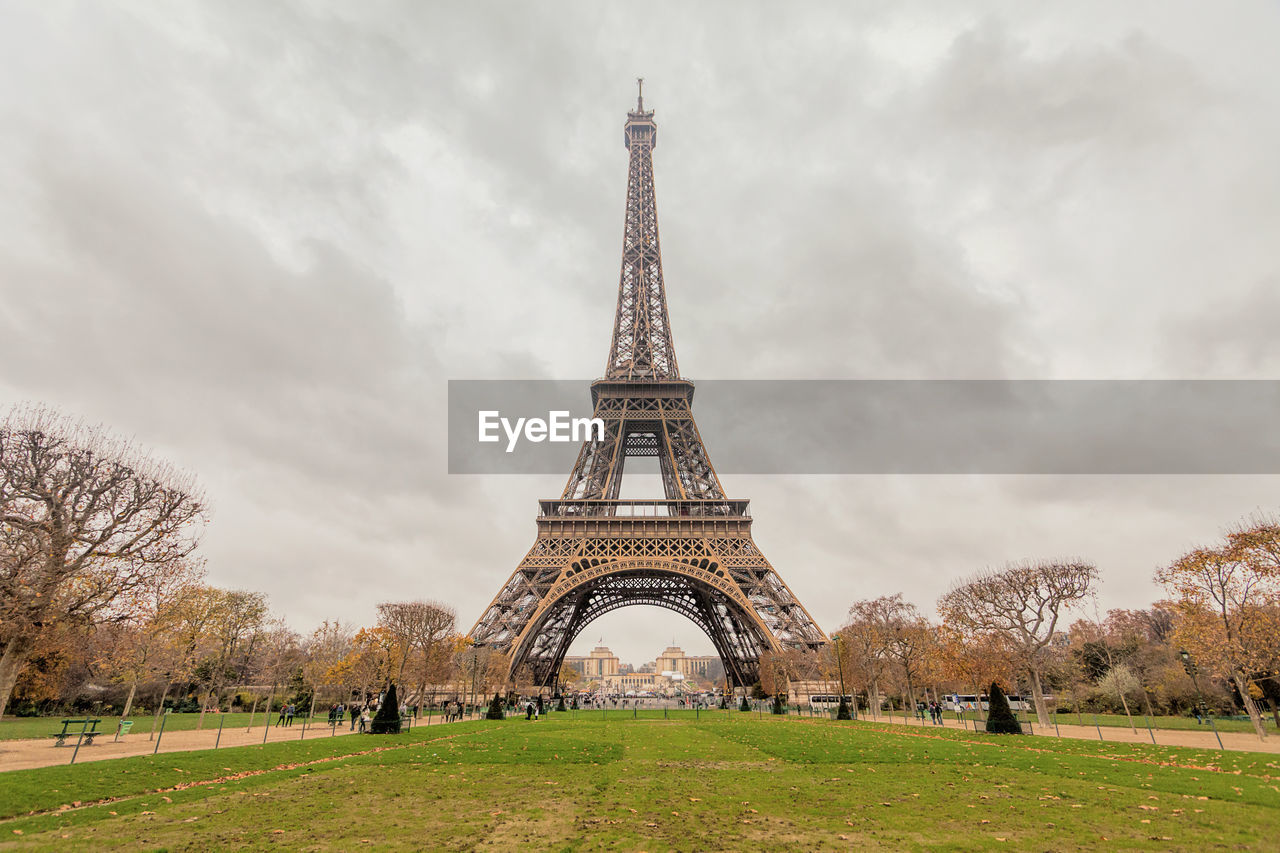 Low angle view of eiffel tower against cloudy sky