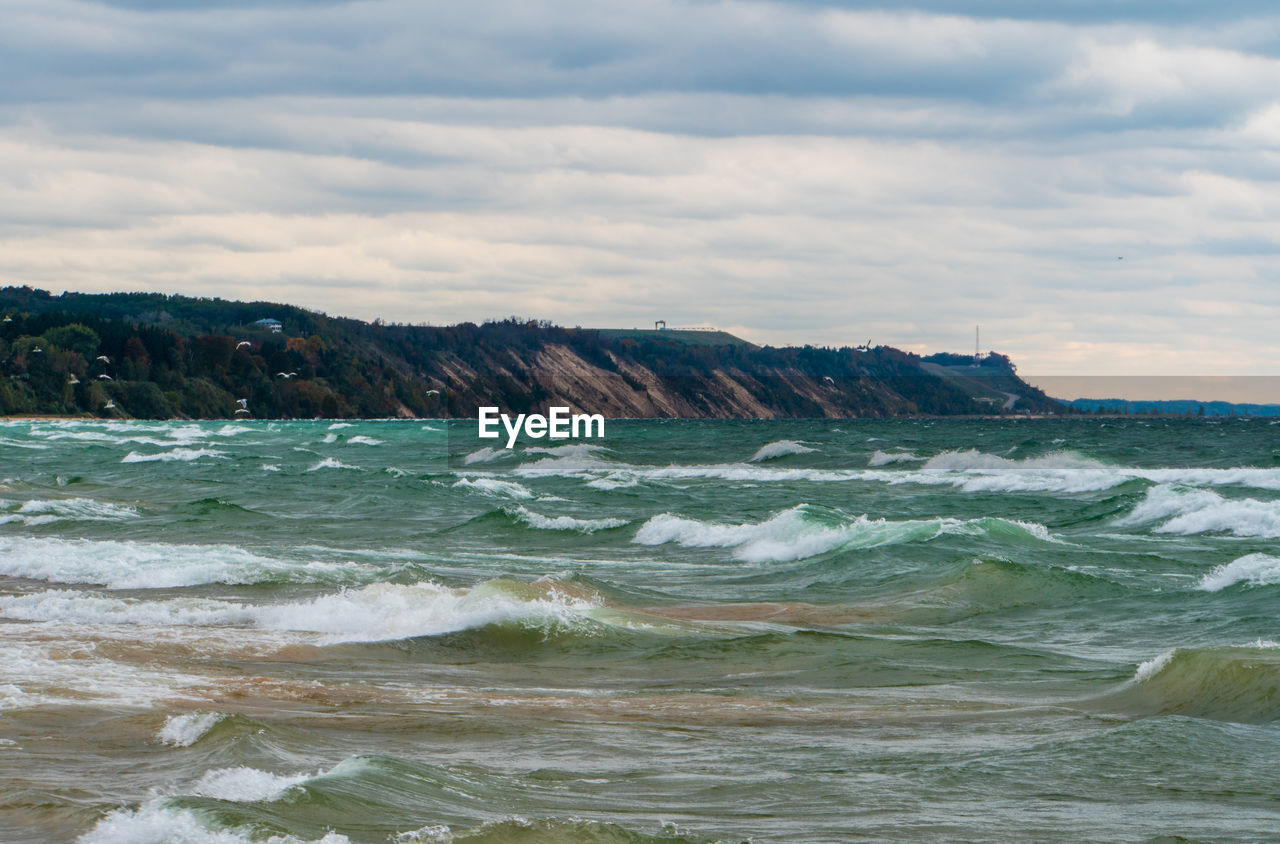 SCENIC VIEW OF SEA AND ROCKS AGAINST SKY