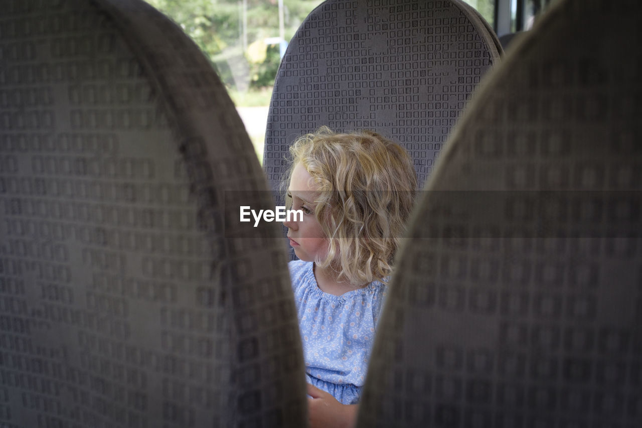 Portrait of a girl looking away on bus