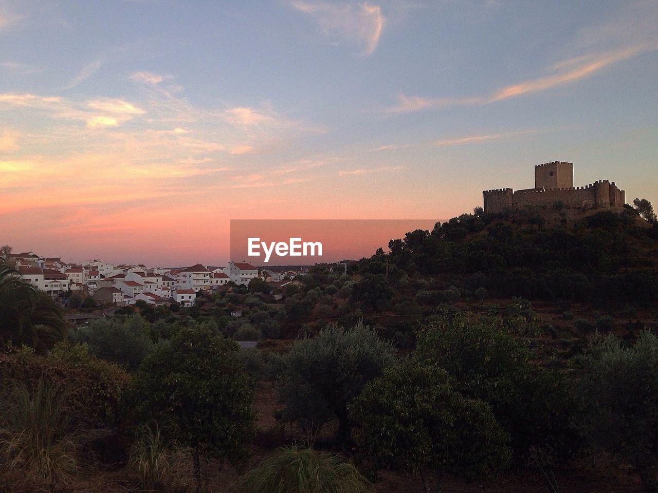 SCENIC VIEW OF CITYSCAPE AGAINST SKY AT SUNSET