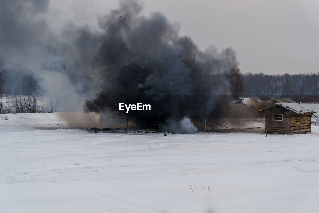 View of black smoke in field