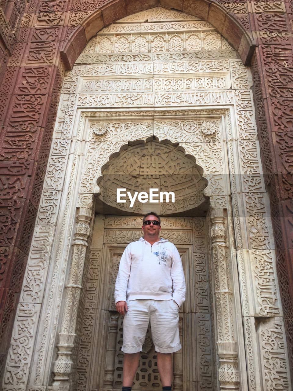 Low angle view of man standing against built structure