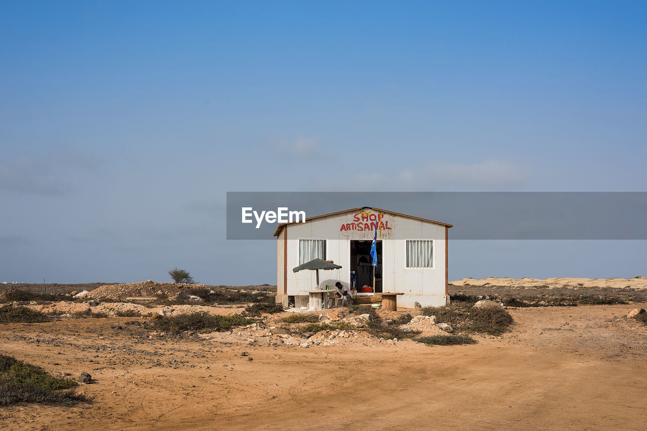 HOUSE ON BEACH AGAINST SKY