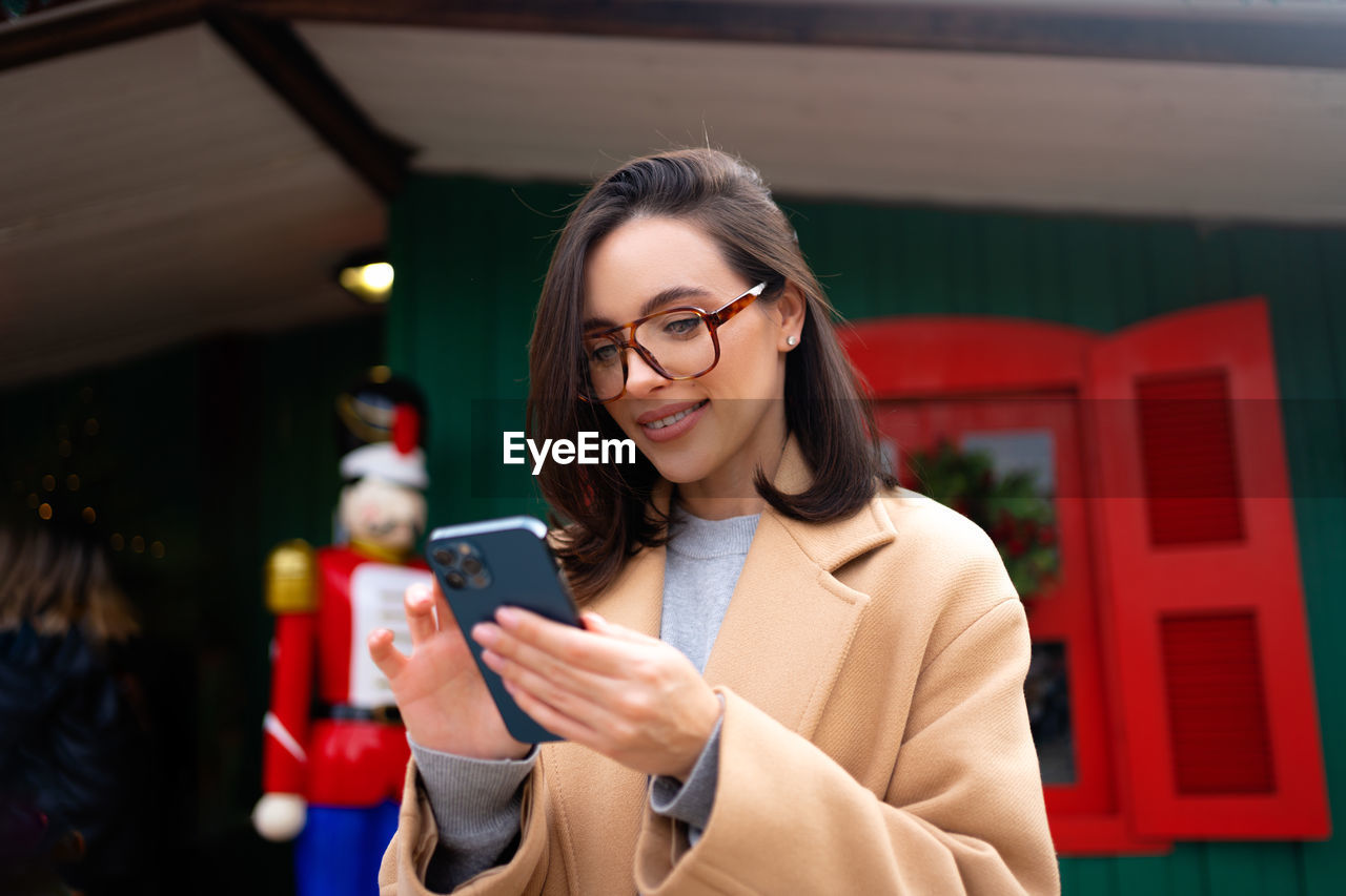 portrait of young woman using mobile phone