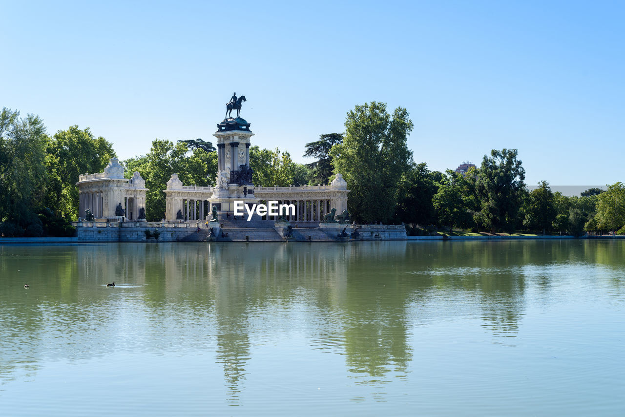 Buen retiro park in madrid, spain. the pond and king alfonso xii monument