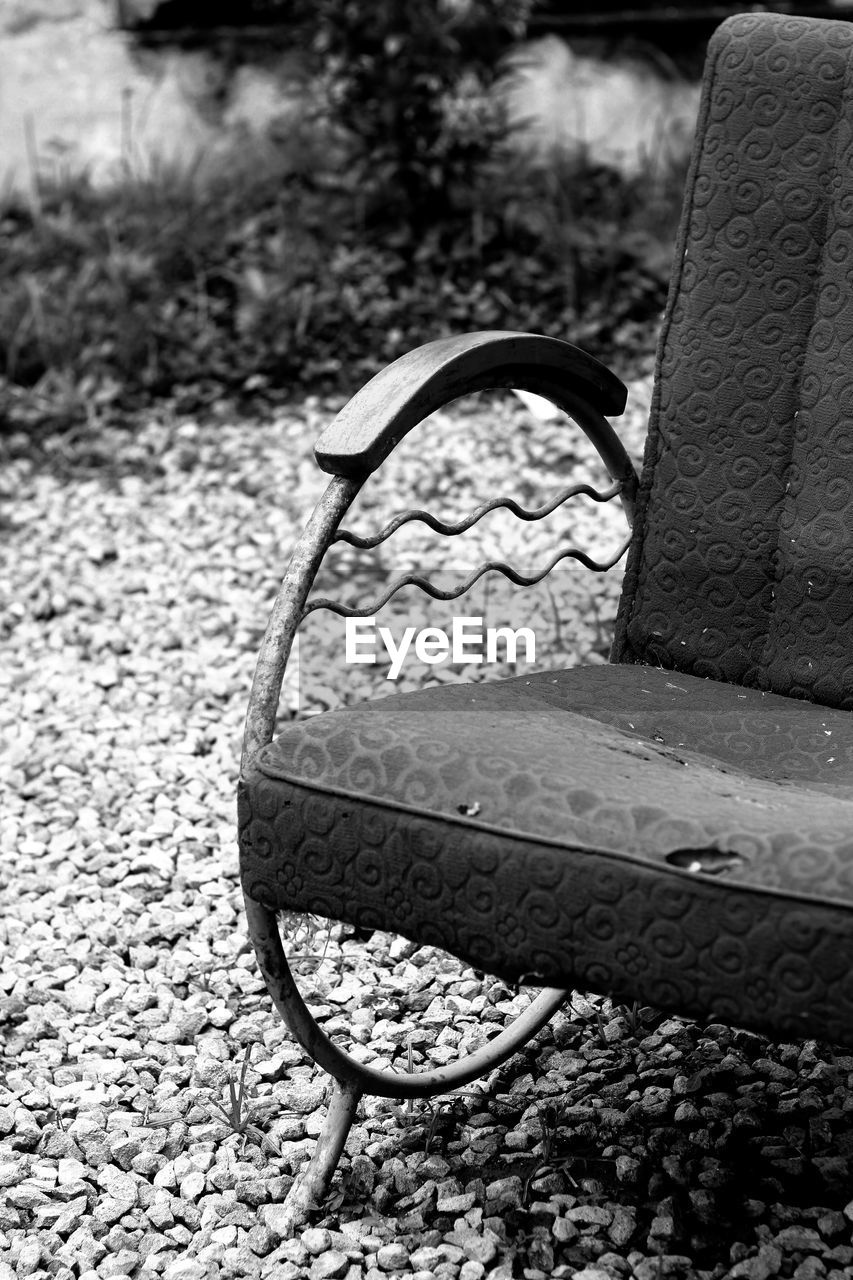 black and white, monochrome photography, black, monochrome, white, no people, furniture, day, nature, seat, iron, outdoors, park, chair, bench, focus on foreground, close-up, park - man made space, high angle view, absence, sunlight, plant, metal, footpath, stone