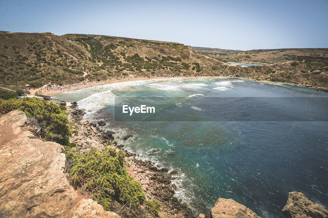 High angle view of scenic sea by mountain