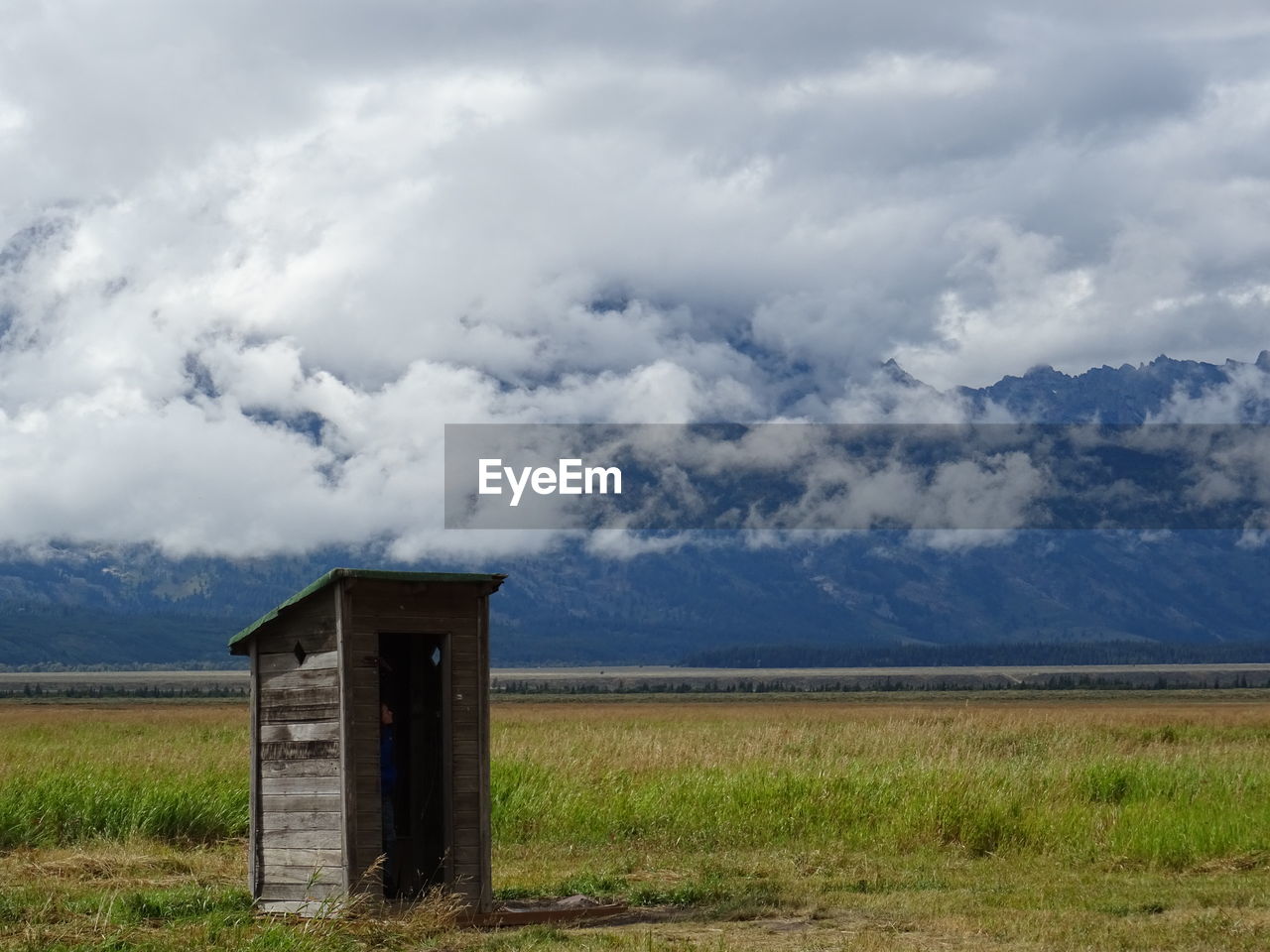 Abandoned house on field against sky