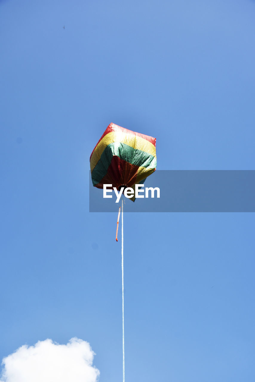 Low angle view of balloon  against blue sky