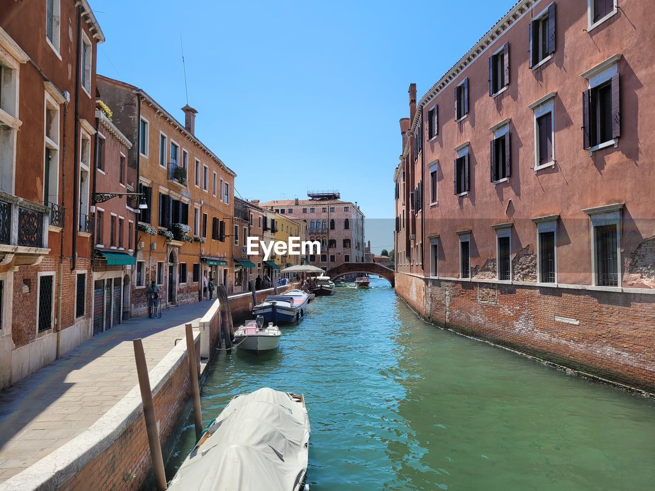 canal amidst buildings against sky