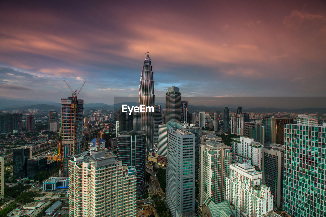 Aerial view of city buildings during sunset