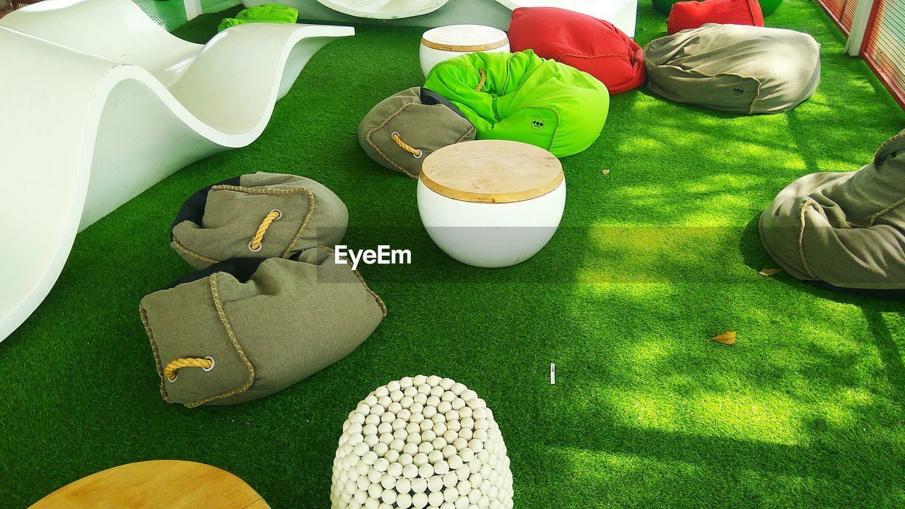 HIGH ANGLE VIEW OF PLANTS AND TABLE ON GRASS