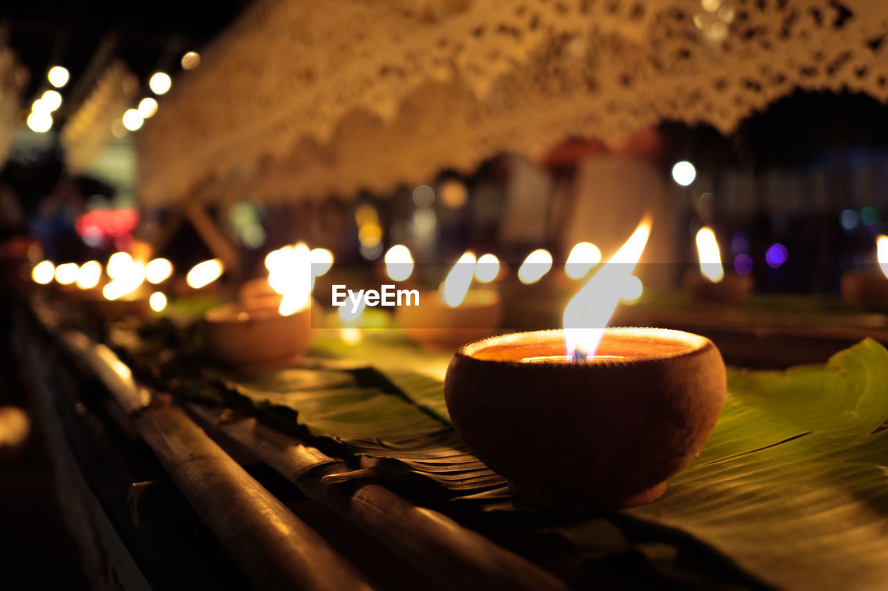 Close-up of illuminated diya at night