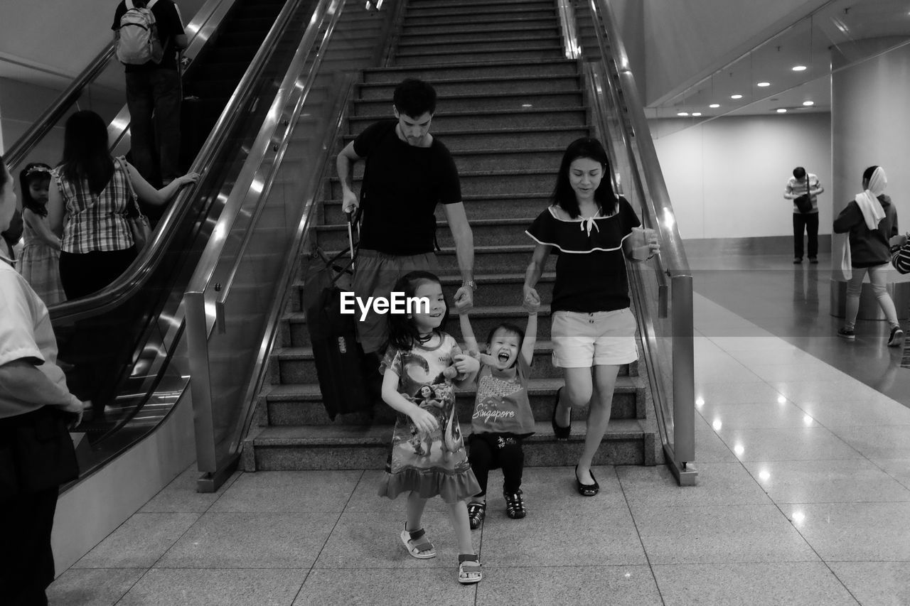 PEOPLE ON ILLUMINATED SUBWAY STATION