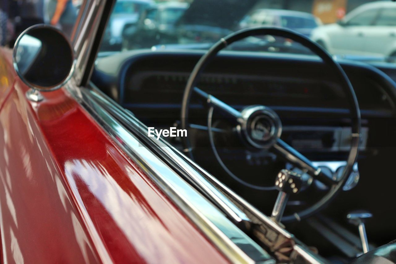 CLOSE-UP OF VINTAGE CAR WITH CAMERA