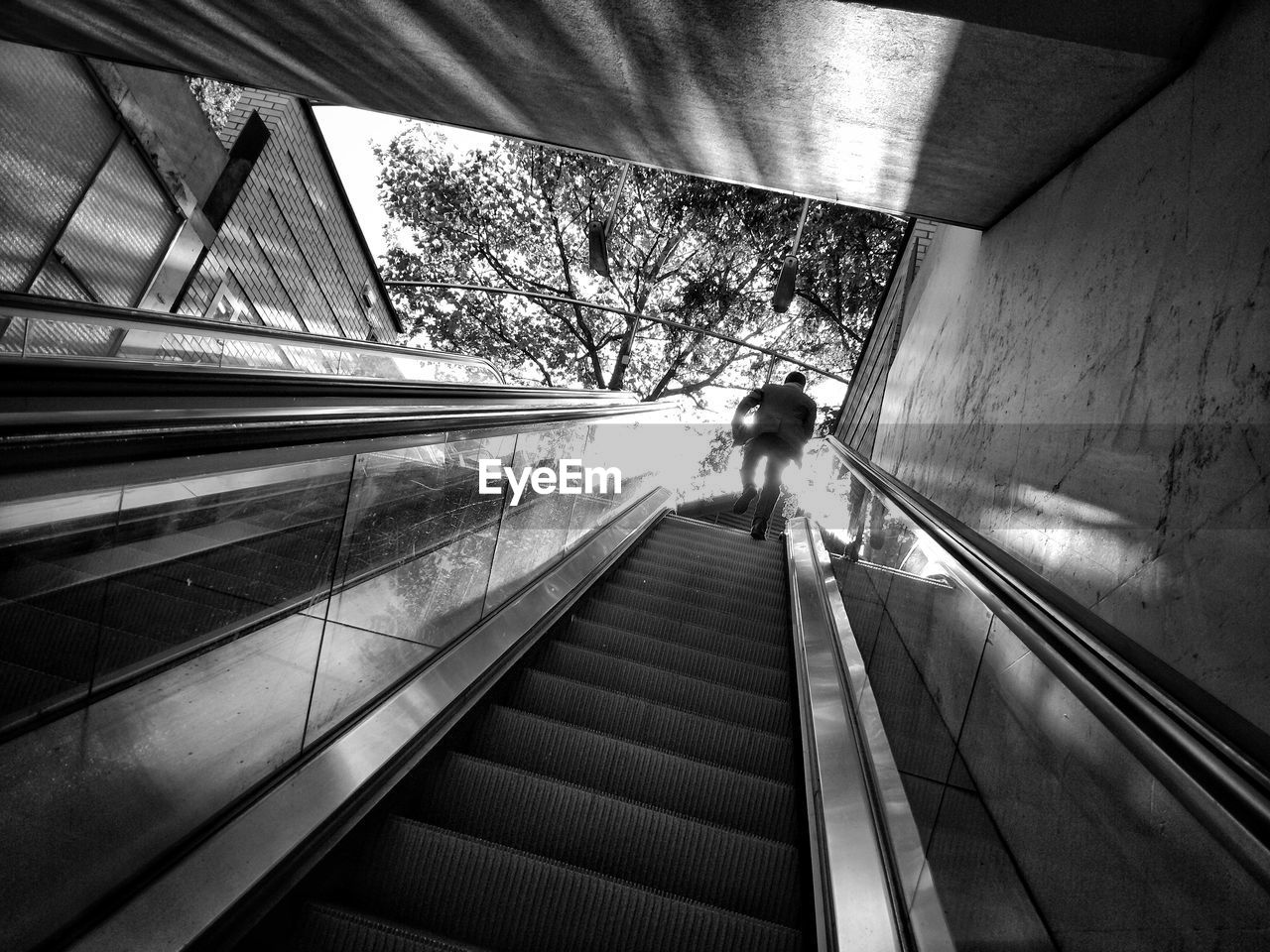 MAN MOVING DOWN STAIRCASE