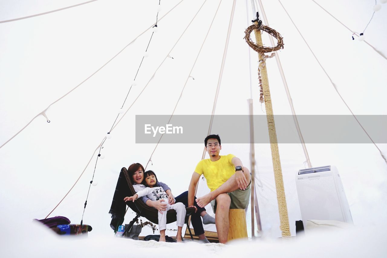 Portrait of family sitting in tent