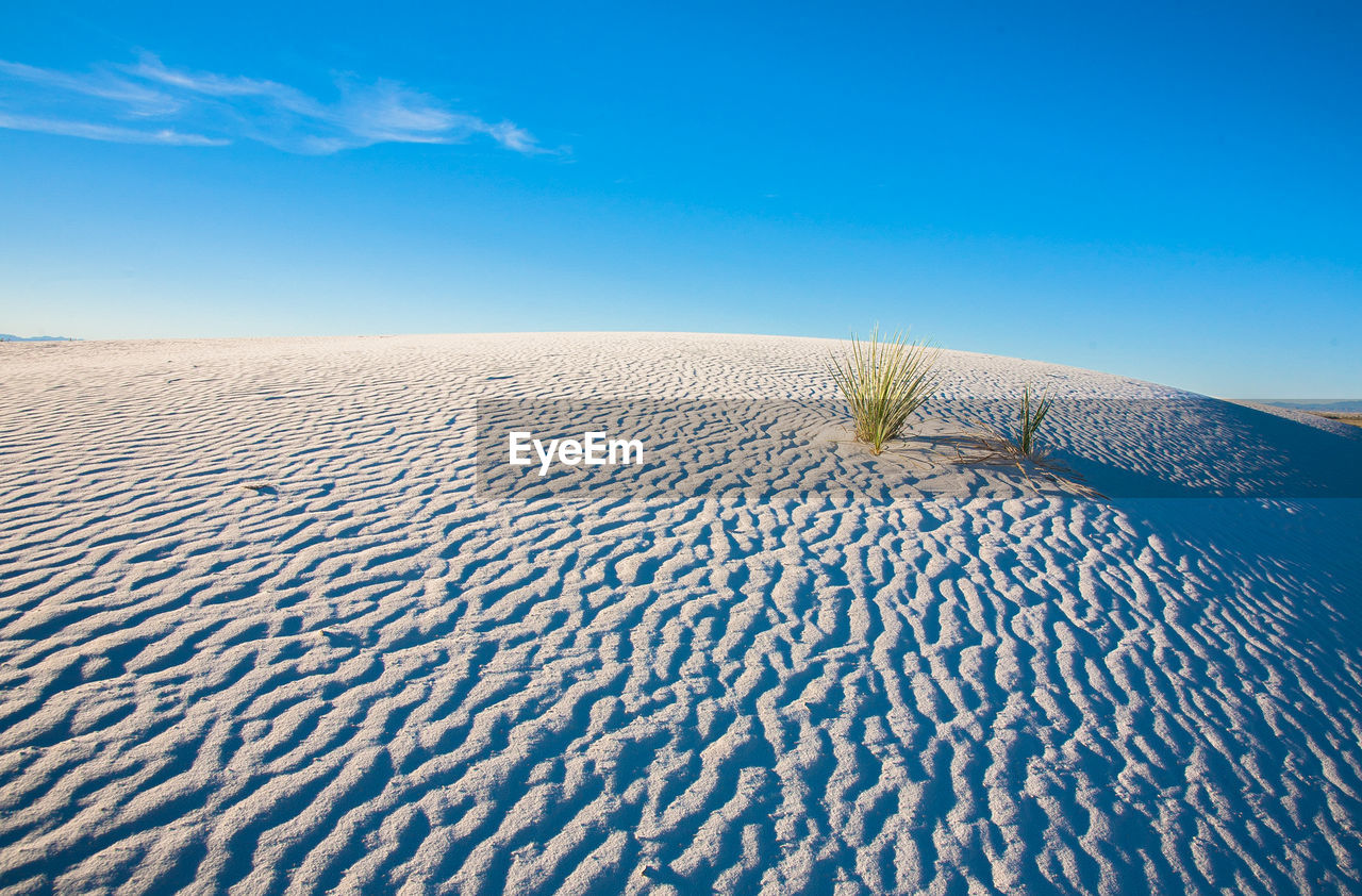 Scenic view of sand dune against sky