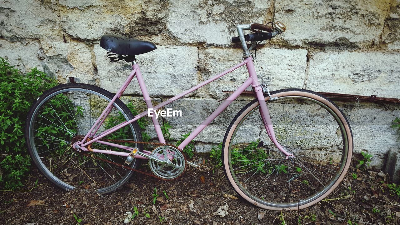 Bicycle parked against wall