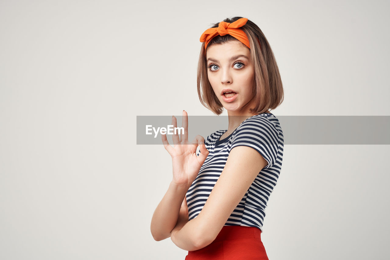 portrait of woman standing against white background