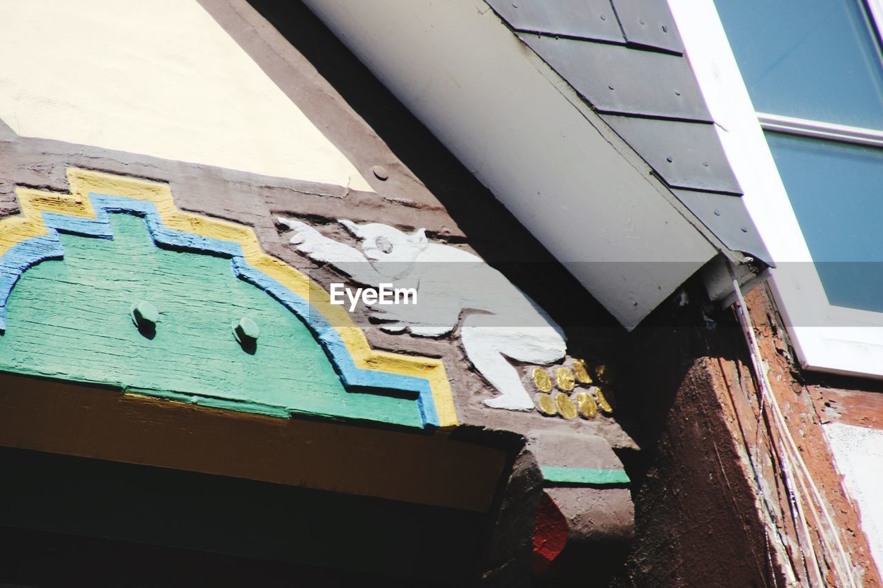 LOW ANGLE VIEW OF GRAFFITI ON BUILDING WALL