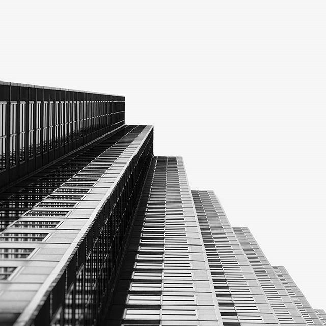 LOW ANGLE VIEW OF MODERN BUILDINGS AGAINST CLEAR SKY