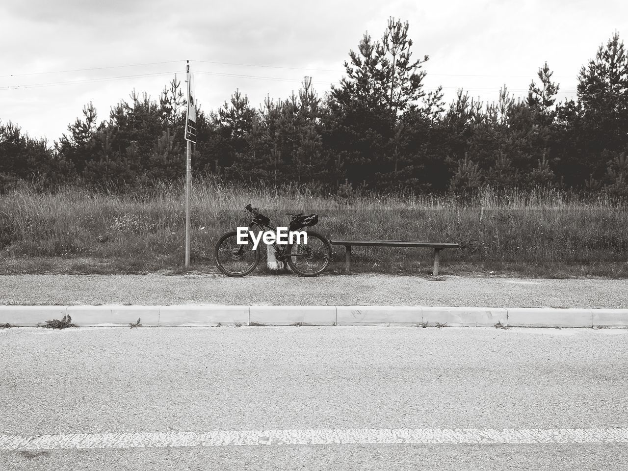 Bicycle by road against sky