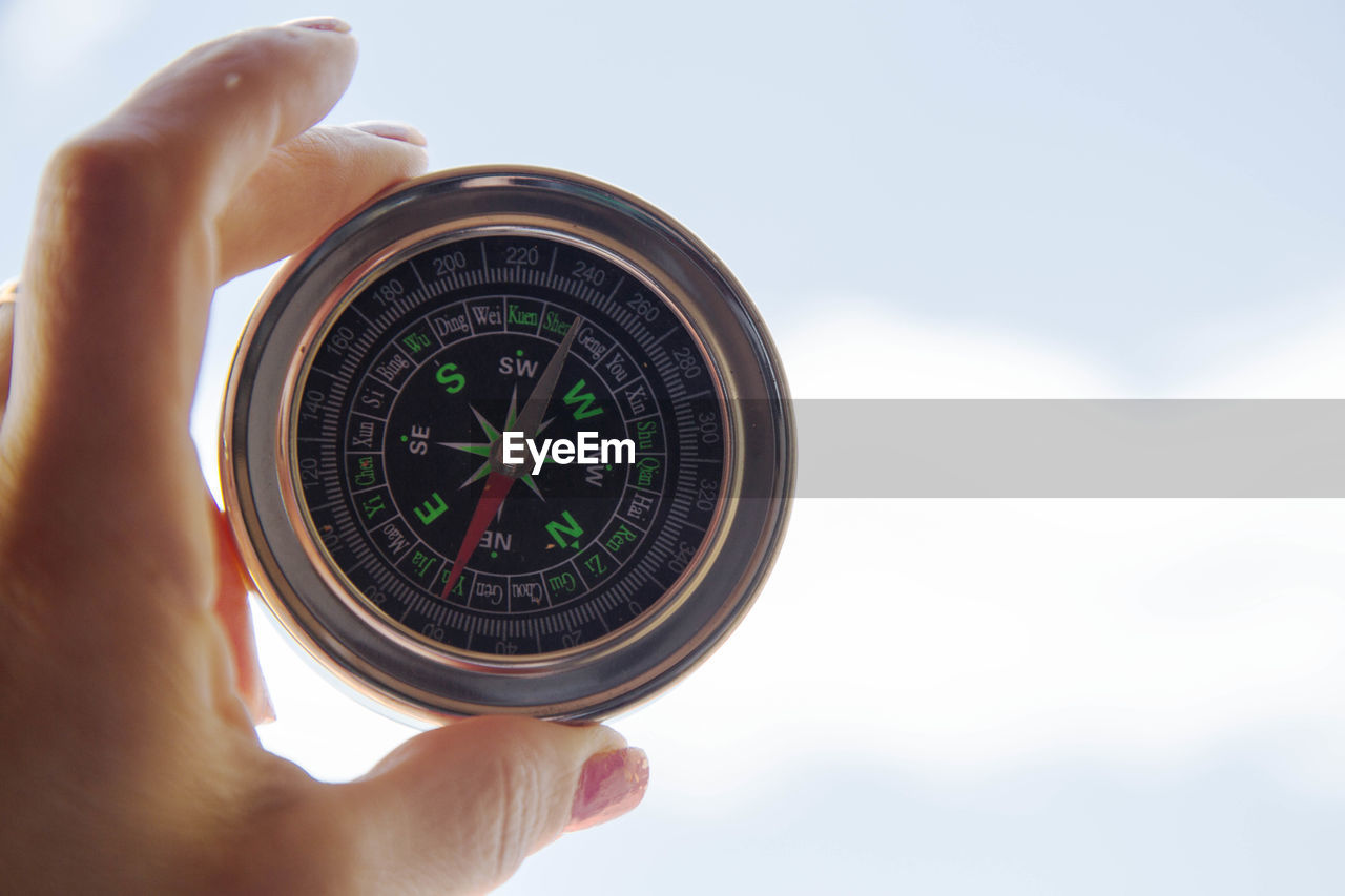 Close-up of female holding navigational compass