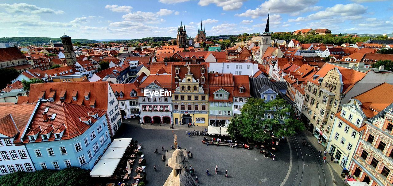 HIGH ANGLE VIEW OF STREET AMIDST BUILDINGS IN TOWN