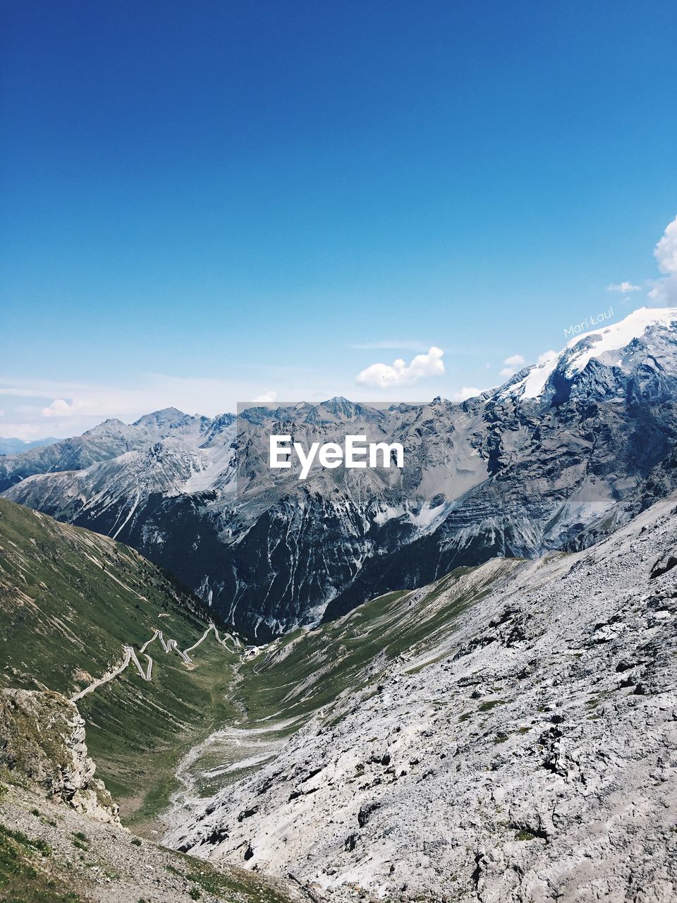 Scenic view of snowcapped mountains against clear blue sky