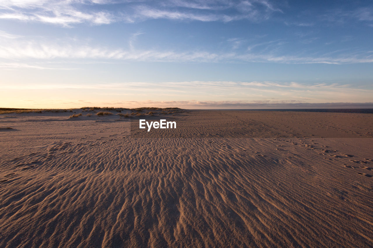 Scenic view of beach against sky during sunset