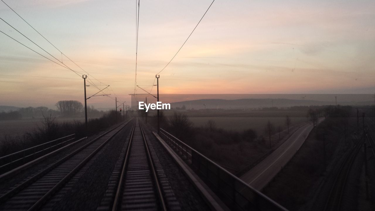 High angle view of railroad track against sky during sunset