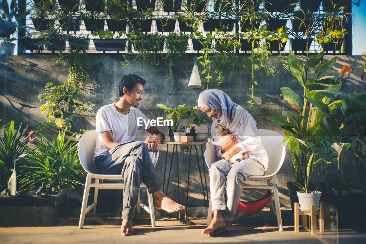 Couple sitting on chair at table