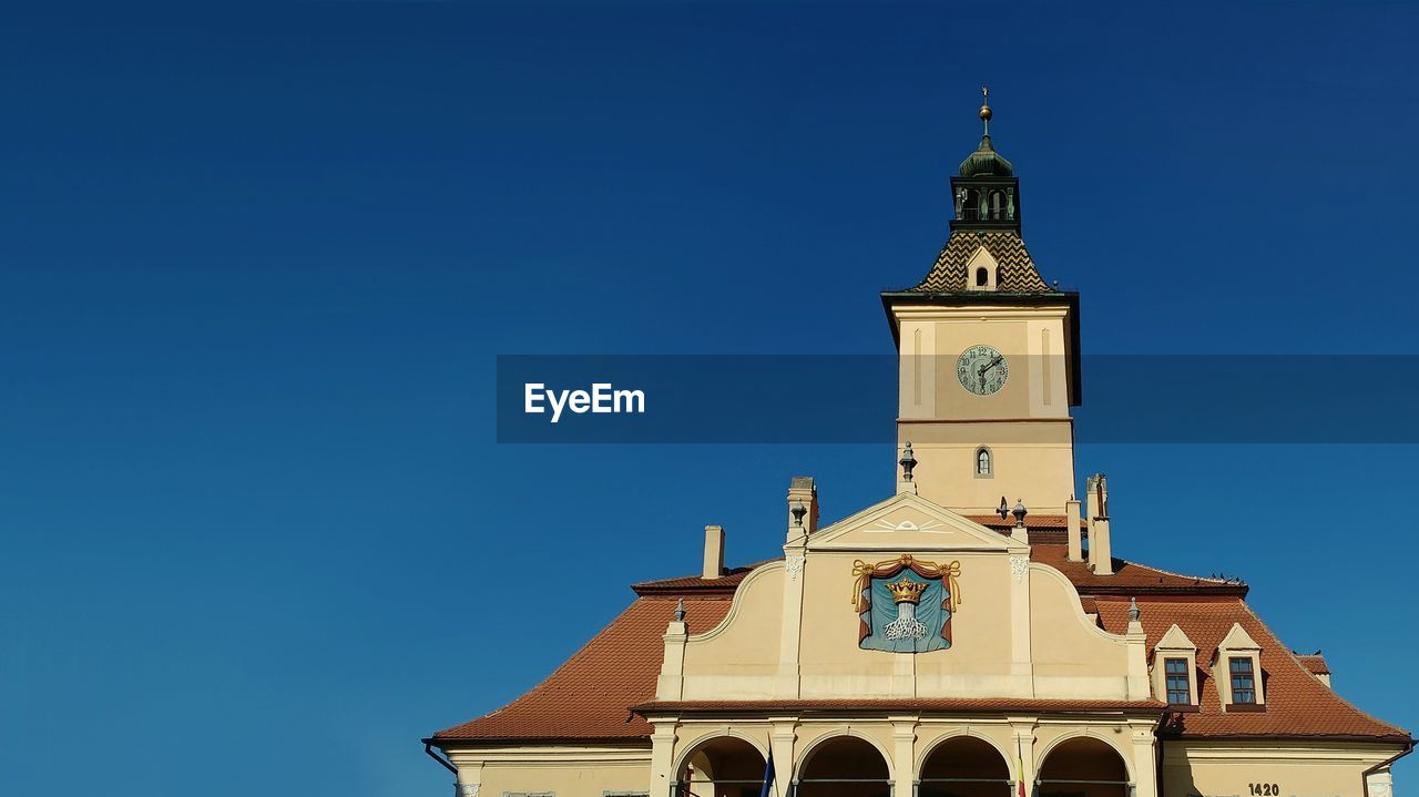 Low angle view of museum of history in brasov clear blue sky